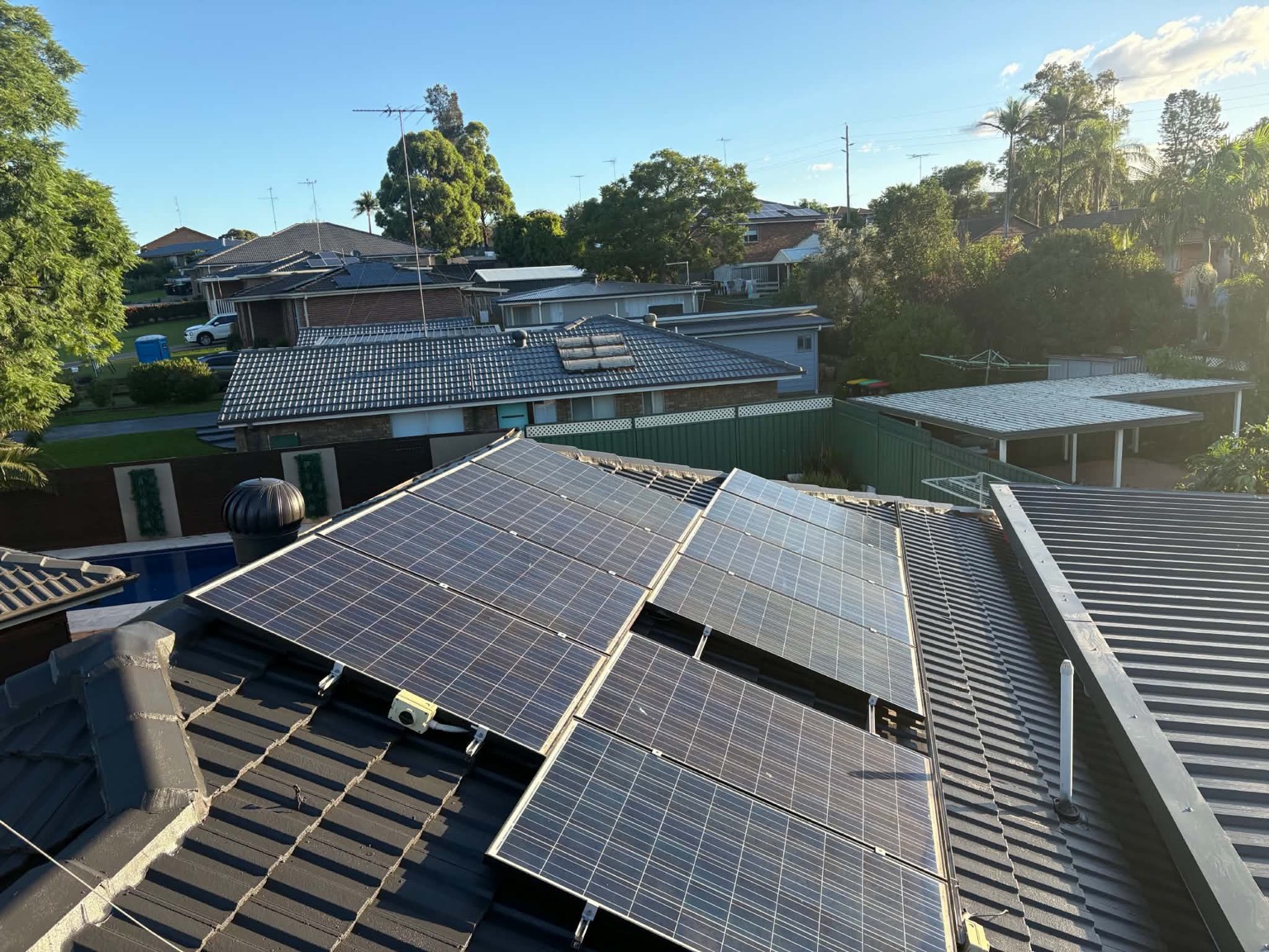 The same roof after restoration in charcoal, with the solar panels in place